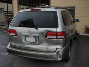 Silver van with dented rear