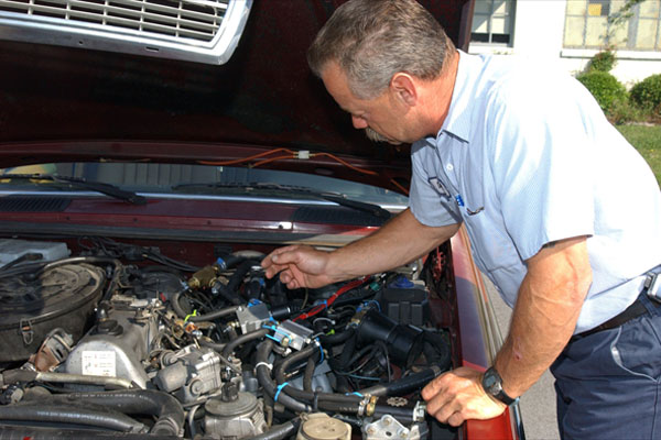 Mechanic checking car engine